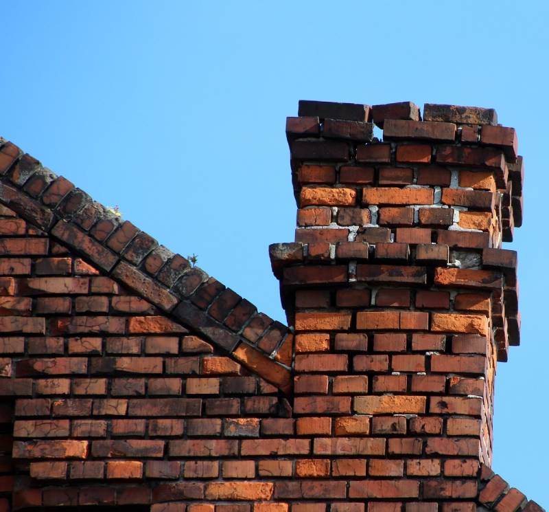 Damaged chimney on an Benbrook home showing cracks and missing mortar